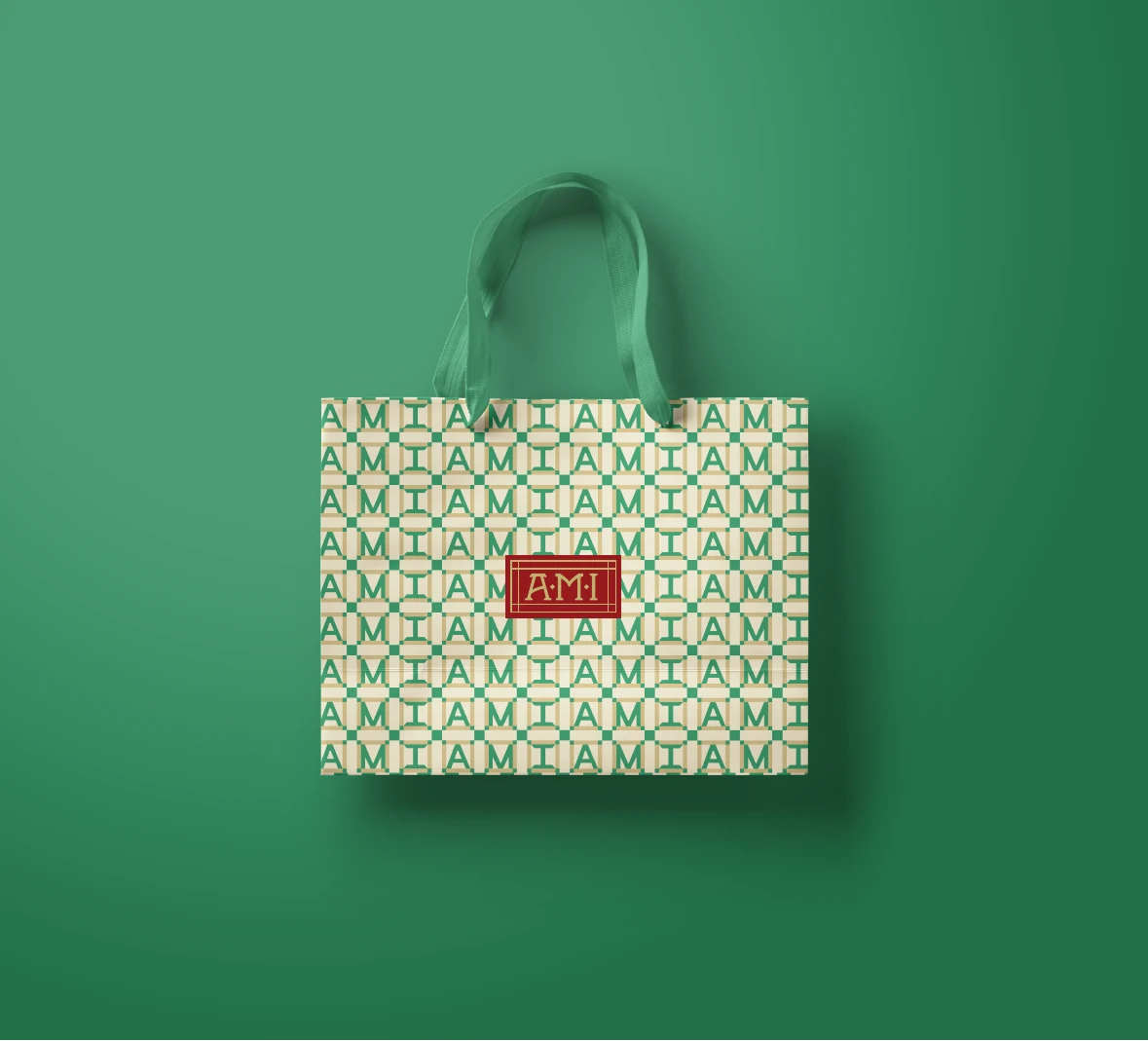 AMI green and cream patterned bag with a red wordmark label