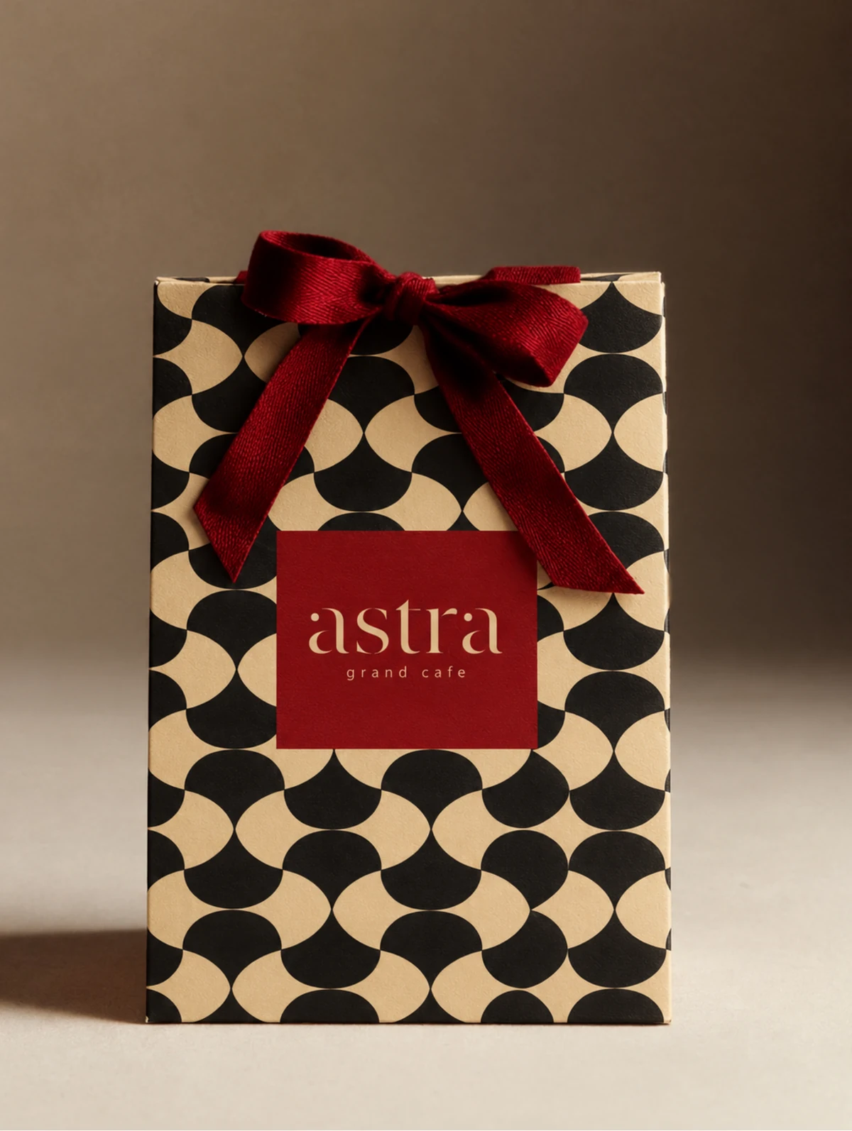 ASTRA patterned gift bag with a red ribbon and wordmark panel