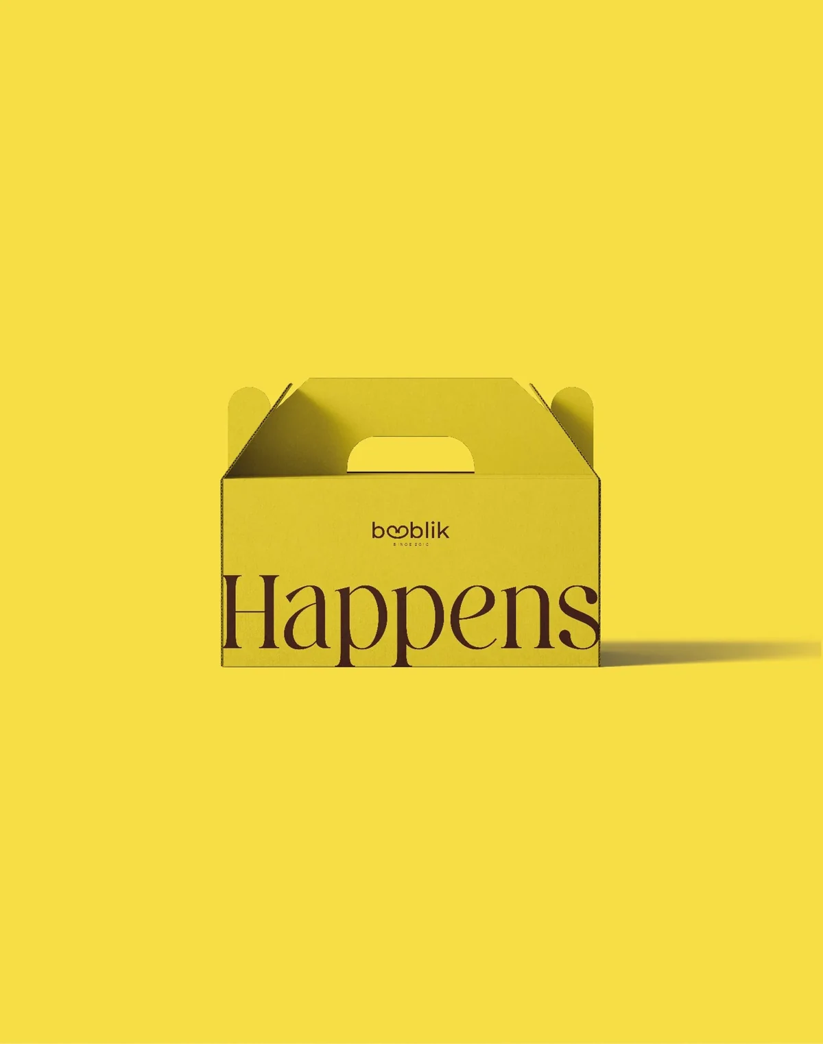 BOOBLIK bright yellow handled carry box with oversized brown serif lettering